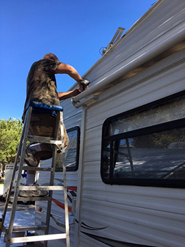Ron Baker of RVs of Texas working on Slideout room awning