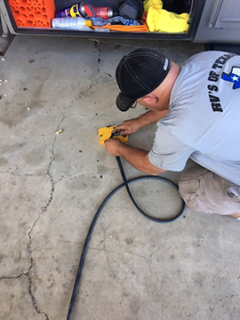 RVs of Texas Technician measuring trim for compartment doors